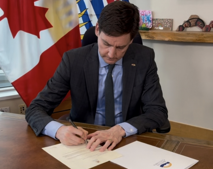 BC Premier David Eby signs documents in tariff dispute with US